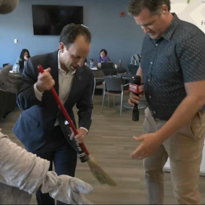 Buddy Bat makes Mayor Craig Greenberg clean up confetti during Give for Good Louisville